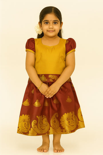 Mustard and maroon Pattu Pavadai for girls with temple-bell motif skirt and zari peacock border
