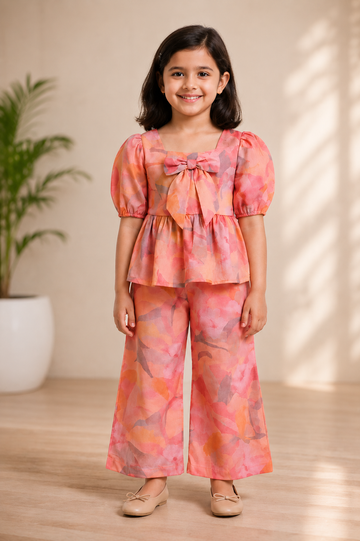 Peach Pink Abstract Print Peplum Top with Bow & Matching Wide-Leg Pants – Soft & Stylish Co-Ord Set for Girls
