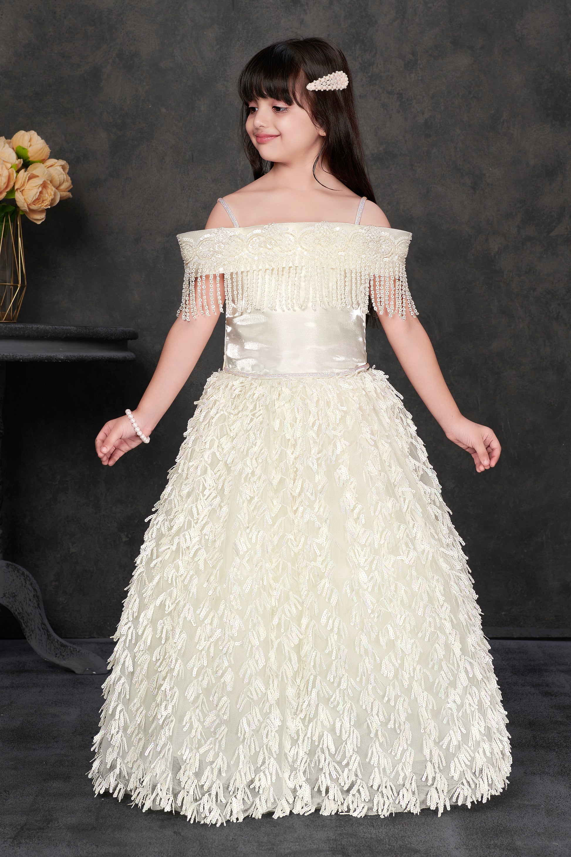 Ivory off-shoulder party gown for girls with fringe and sequin detail