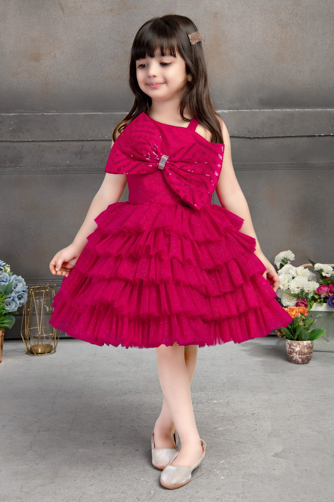 Raspberry ruffle party dress for girls with oversized sequin bow