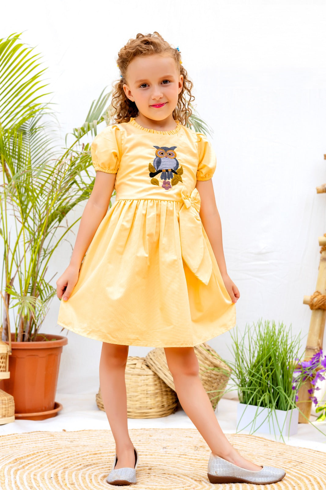 Yellow cotton frock for girls with puff sleeves and owl embroidery