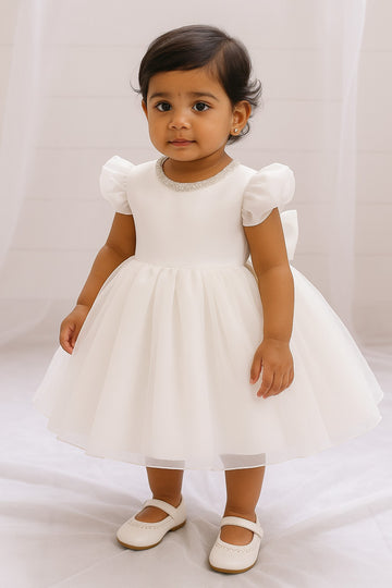 White baby gown with pearl neckline and flowing layered skirt